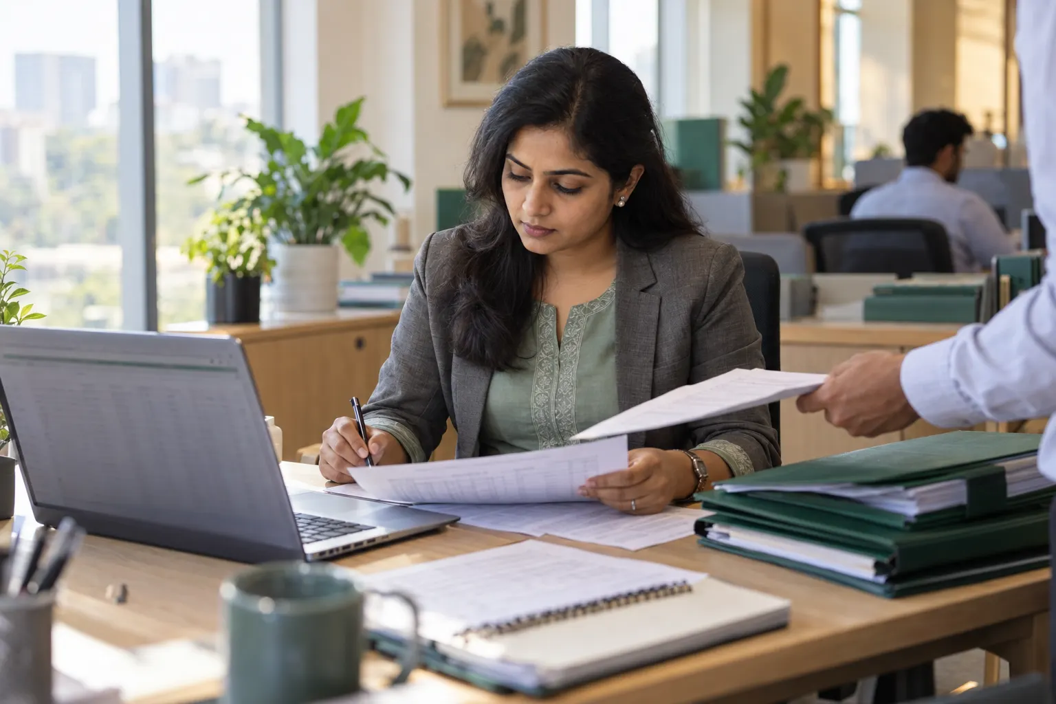 A compliance executive checking state Professional Tax returns at a desk.